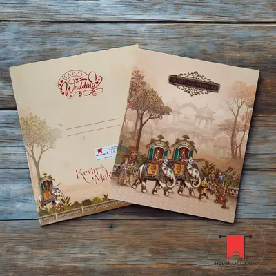 Announce your wedding with the grandeur it deserves. This invitation features a classic Raja-Rani theme, depicting a royal procession with elephants, perfect for a traditional Indian ceremony.