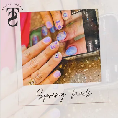A fun and trendy spring nail design that was created based on a client's reference photo. This set features a mix of pastel purples, delicate floral patterns, and a protective evil eye symbol for a personalized touch.