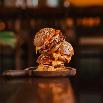 Here is a troika that never fails to win hearts. The hickory smoked pulled pork, the savory smashed lamb, and the classic smashed beef onion burger. Time slows down, flavors pop, and the simple joys of life unravel with each bite.