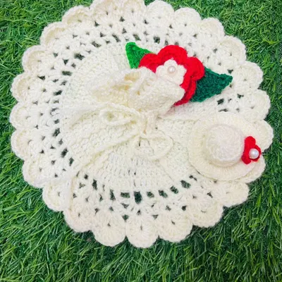 An elegant off-white summer dress featuring a delicate red rose and a matching crochet hat. This lightweight poshak is perfect for keeping Kanha Ji cool and stylish.