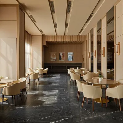The main dining and gathering space in the Elemental banquet hall, featuring a trapezoidal floor plan with an acoustically treated ceiling and abundant natural light from the glass façade.