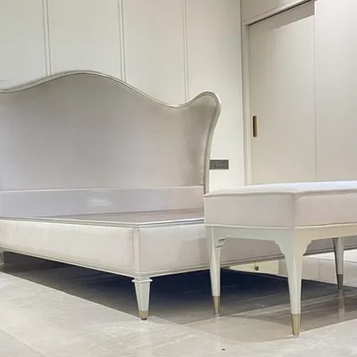This Bedtime Beauty offers regal style with its dramatically updated camel-back headboard and generous curving wings. The exposed, exquisitely carved wood rail is finished in a radiant Auric silver leaf and upholstered in a luxury fabric for refined elegance.