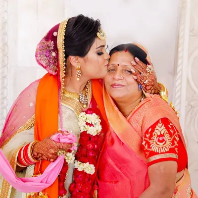 A daughter's loving kiss for her mother during a family celebration. These are the timeless, emotional photographs that become treasured family heirlooms, capturing the bond between a mother and daughter.