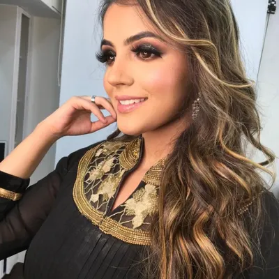 A perfect example of a party glam look. The smokey eye, defined brows, and contoured features are ideal for an evening event or reception.
