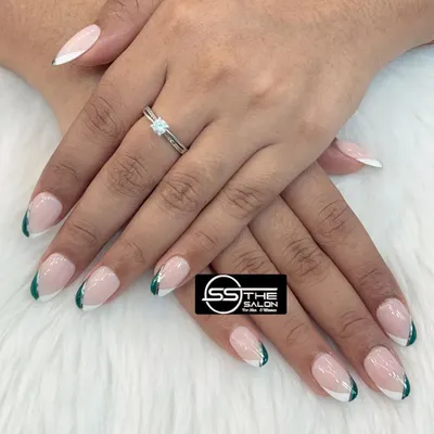 A fresh and modern update to the classic French manicure. This design features a clean, angled tip with a dual-color combination of crisp white and deep forest green for a chic, contemporary style.