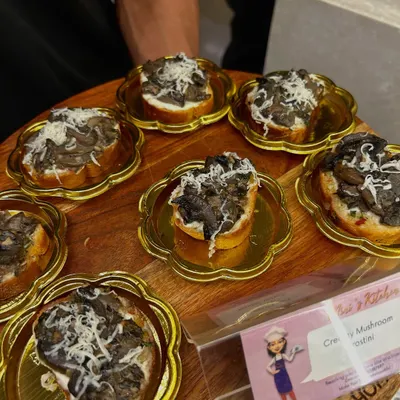 My Creamy Mushroom Crostini served on elegant, flower-shaped golden plates. Presentation is key, and I make sure every detail contributes to a high-end experience.