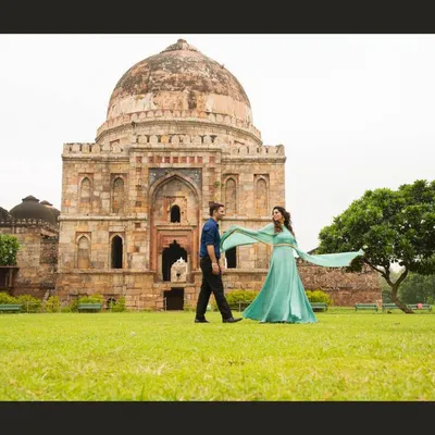 A grand, cinematic shot at Lodhi Garden in Delhi. Using historical monuments as a backdrop adds a sense of timelessness and scale to pre-wedding photos.
