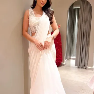 A guest looking radiant in a white ruffled sari at the Ridhi Mehra event. I ensure the guestlist includes people who genuinely appreciate and embody the designer's aesthetic.