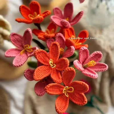 A beautiful overhead shot of the open-petal crochet tulips. The warm tones of orange and pink create a stunning visual, perfect for a vibrant, modern bouquet.