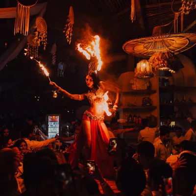 Performing on a raised stage in a packed venue. This image captures the energy of a live show, where we engage directly with the audience to create an unforgettable, high-energy experience.