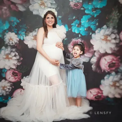 A beautiful maternity portrait with an older sibling. Capturing the excitement of the big sister-to-be is a special part of the journey.