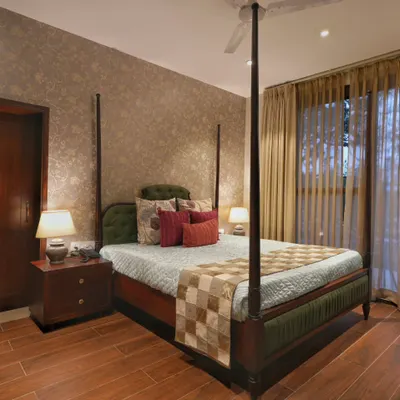 The highlight of this bedroom in the Doon Homestay is the four-poster bed, which exudes luxury. We paired it with a textured wallpaper in a neutral tone and rich wooden flooring to create a warm, opulent, and restful environment.