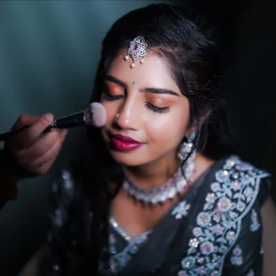 Here's a glimpse of my process. I'm applying a soft blush to add a natural, healthy color to the cheeks. Every step is done with care to create a flawless look that feels as good as it looks.