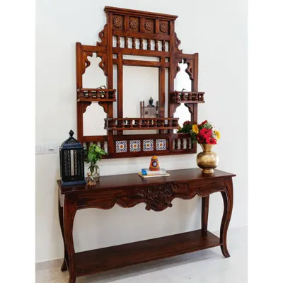 Inspired by the timeless elegance of Rajasthani architecture, this ornamental jharokha-style mirror and console table set makes a grand statement in the entryway. The intricate carving, tile inlays, and multiple mirrors add a touch of traditional opulence.
