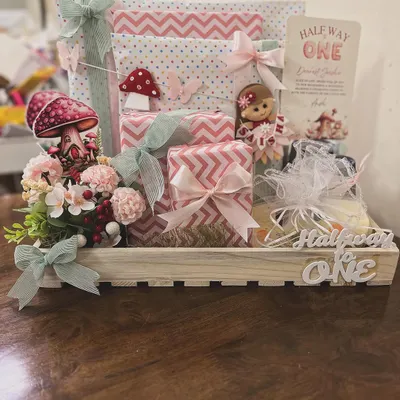 I love celebrating all the little milestones, including the quirky ones. This "Halfway to One" hamper was designed for a six-month celebration, using a whimsical fairy and mushroom theme to create a magical gift for a baby girl's special day.