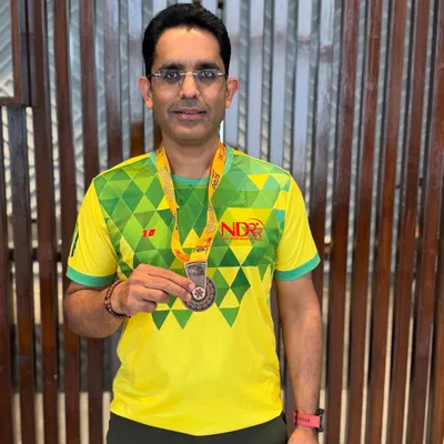 A proud moment for one of our runners, showing off his well-earned medal after a race. Every finish line is a victory.