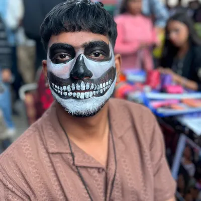 When someone says face painting is only for girls, I show them this. A classic black and white skull design is one of the most requested looks for men at music festivals and Halloween parties.