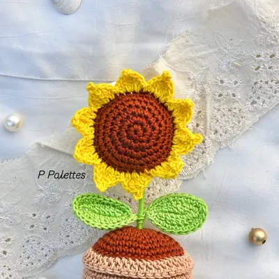 Turning strings into beautiful things. This is a close-up of our adorable potted crochet sunflower, showing the intricate stitch work.