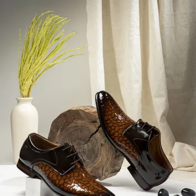 This shot of two-tone formal shoes was styled to convey classic elegance. I used a clean background with natural elements like wood and dried grass to create a sophisticated look perfect for a men's luxury footwear brand.