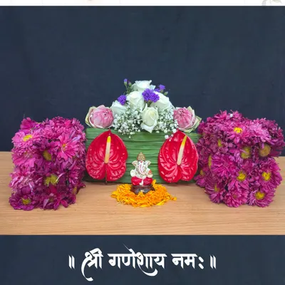 A beautiful and modern floral tribute to Lord Ganesha, created by one of our talented students. This design blends traditional elements with contemporary flowers like anthuriums and roses, showcasing a unique approach to festive decor.