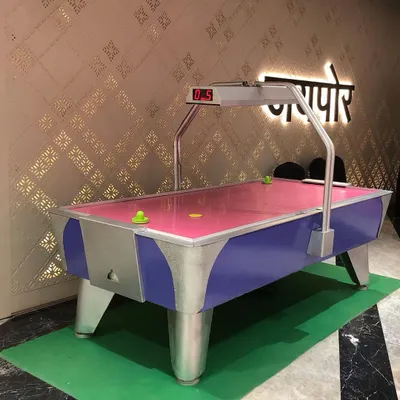 A full-sized air hockey table ready for play. This rental includes the pucks and strikers, providing everything needed for fast-paced, competitive fun at any event. The overhead scoreboard keeps track of the action.