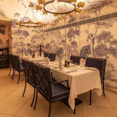 Our indoor dining room is set and ready for evening service. The long table is perfect for group celebrations or family dinners in a sophisticated setting.