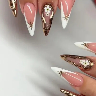 A high-fashion, mixed-media set featuring stiletto nails with white French tips, 3D gold chrome, and delicate hand-painted flowers.