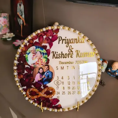 A special keepsake for a client, preserving their thali thread and varmala flowers in a circular resin frame. I also included their names and a calendar marking their special date, making it a truly personalized piece of wedding memorabilia.