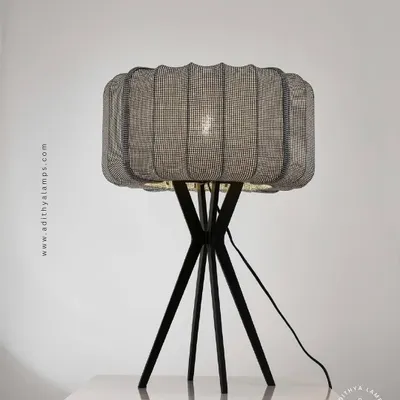This lamp series features a distinctive woven mesh shade on a tripod base, available as both a floor and table lamp. The design offers a modern yet slightly industrial feel, casting a beautifully diffused light.