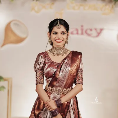 A stunning portrait of a South Indian bride on her wedding day. Her traditional silk saree, intricate jewelry, and happy smile are the focus of this timeless shot.