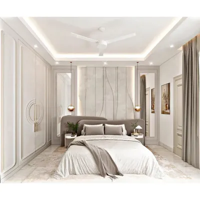A luxurious and symmetrical bedroom design featuring paneled walls and integrated wardrobes. The soft grey tones, plush headboard, and elegant pendant lights come together to create a sophisticated and tranquil atmosphere.