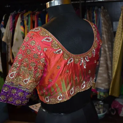 The back view of the custom silk blouse, showcasing the continuity of the detailed Kundan and zardozi work. Every angle is designed to look flawless.