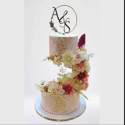 An exquisite anti-gravity engagement cake with a soft pink stencil design and a cascade of handmade sugar flowers. The floating tier creates a magical effect for a truly special celebration.