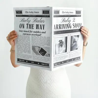 Extra, extra, read all about it. Using a custom "The Baby Times" newspaper is a fun and unique way to announce your pregnancy.