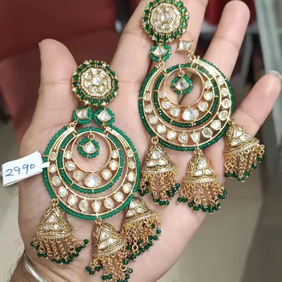 These large chandbali earrings with attached jhumkas are a statement in themselves. Made with kundan and green beads, they are perfect for when you want your earrings to be the hero of your look.