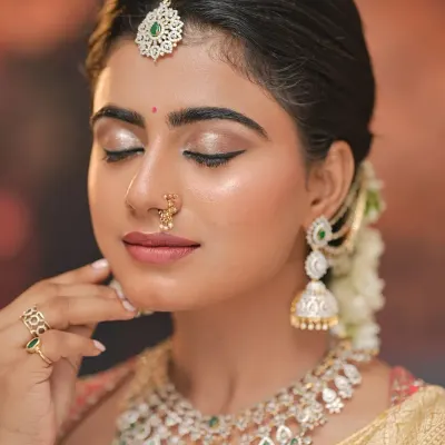 A close-up of a classic South Indian bridal look. Notice the shimmering eyeshadow, sharp winged liner, and the perfectly blended base that gives a radiant glow.