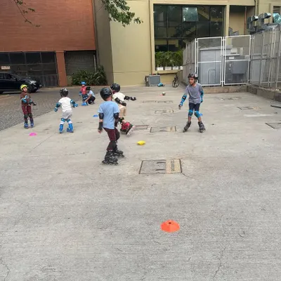 A group of young skaters learns together in their apartment complex. We bring our expert coaching and all the necessary safety gear to you, making it easy and convenient to learn to skate.