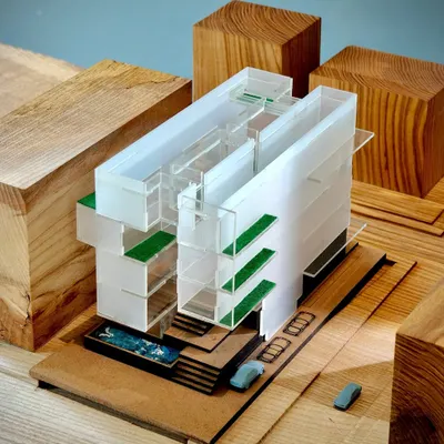 A conceptual model for a residence in New Delhi, using acrylic and wood to study the interplay of solid and void. The green terraces and pool are integrated early in the design process to create a dialogue between the structure and nature.