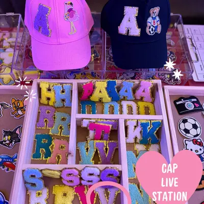 A look at our live cap customization counter, fully stocked with colorful initial patches and fun character designs. We bring everything needed to make your event's return gifts interactive and memorable.