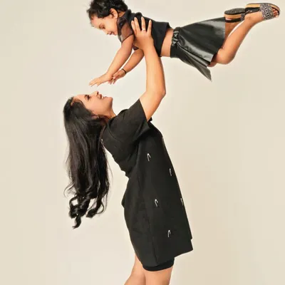 Pure, unfiltered joy! A mother lifting her daughter into the air is more than just a photo; it's a feeling of flight, freedom, and the incredible strength of a mother's love. These are the playful moments that define childhood.