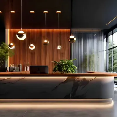 This reception desk for a high-end corporate office uses a dramatic black marble front with under-counter lighting. Paired with a warm wood accent wall and spherical pendant lights, the design creates a luxurious and modern welcome.