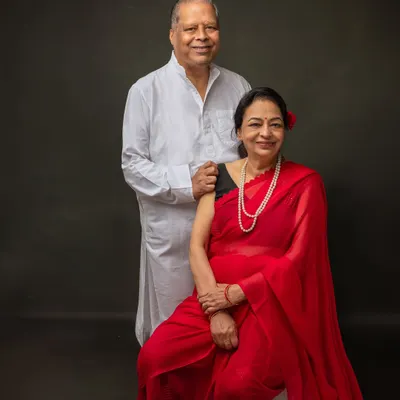 A portrait of my parents, the heart of our family. Capturing them together is a way to honor their legacy and freeze a moment of their love and connection in time. The classic red saree and white kurta create a timeless look.