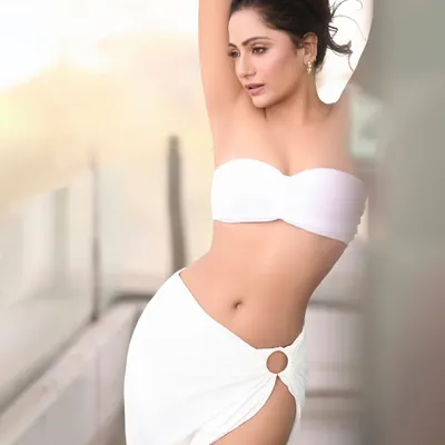A bright, airy outdoor shot in an all-white outfit. The natural light and relaxed pose create a fresh and effortless lifestyle image.