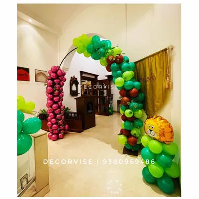 For a jungle-themed birthday, I created this balloon arch to serve as a grand entrance. The combination of different shades of green, pops of red, and a character foil balloon immediately immerses guests in the party's theme.
