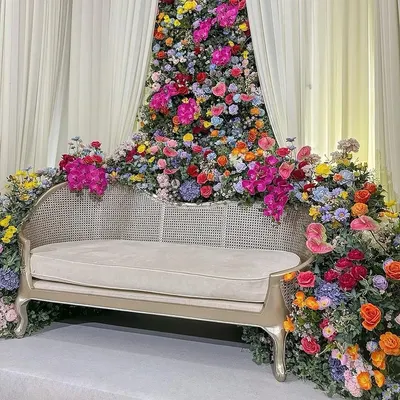 A closer look at the throne of dreams. This angle highlights the intricate placement of dozens of flower varieties, creating a rich texture of colors and shapes around the seating.