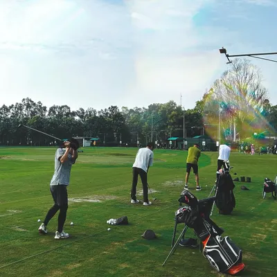 A dynamic shot of our driving range on a sunny day. With plenty of space and multiple golfers in action, it captures the vibrant energy of a weekend at Hamoni.