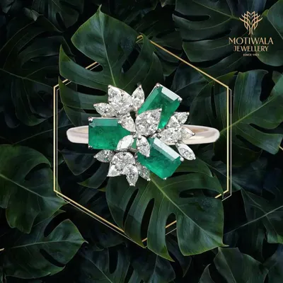 Nature's beauty is captured in this striking ring, where vibrant emeralds are juxtaposed with marquise and pear-shaped diamonds. It is a piece of wearable art for the discerning collector.