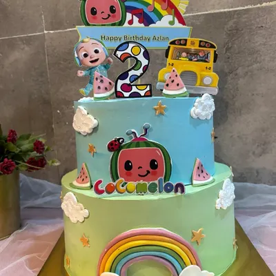 This two tier CoComelon cake is a favorite for second birthdays. It's packed with fun details, including JJ, the yellow bus, and lots of rainbows and watermelons. The pure joy on the birthday boy's face in the next photo says it all.