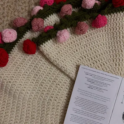 I'm completely obsessed with how this rose bouquet blanket turned out. Here's a close-up shot where you can see the detailed stitching of the blanket and the texture of the pink and red roses along the border.