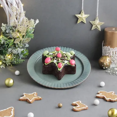 Unwrap the joy of Christmas with our delectable plum cakes. This one is shaped like a Christmas tree and decorated with festive colors, making it a perfect centerpiece.